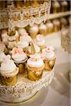 Vanilla Cupcakes in Gold Foil on Stands at Wedding