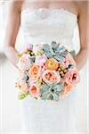 Close-up of Bride holding Bouquet of Flowers