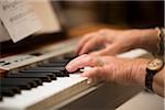 Close-up of Person's Hands Playing Piano