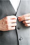 Close-up of Man's Hands Buttoning up Vest