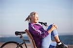 Senior woman enjoying ocean view on bench