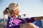 Senior woman enjoying ocean view on bench