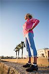 Senior woman stretching by beach