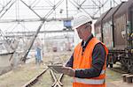 Dock worker using digital tablet at port