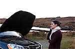 Woman by stalled vehicle at roadside, Connemara, Ireland