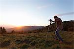 Hiker taking photograph from hilltop, Montseny, Barcelona, Catalonia, Spain