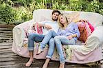 Couple relaxing on vintage sofa in garden