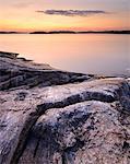 Lakeside rocks on Iso Koirasaari Island at sunset, Ladoga Lake, Republic of Karelia, Russia