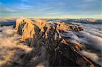 The pinnacles of the Odle Group (Geisler) emerging from the fog, Dolomites, South Tyrol, Italy, Europe