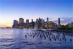 Lower Manhattan skyscrapers including One World Trade Center at sunset from across the East River, Financial District, Manhattan, New York City, United States of America, North America