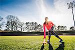 Young female athlete training on sports field