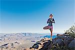 Young female trail runner doing yoga pose on Pacific Crest Trail, Pine Valley, California, USA