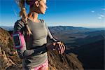 Young female trail runner checking stopwatch on Pacific Crest Trail, Pine Valley, California, USA