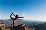 Young female trail runner in yoga pose on rock, Pacific Crest Trail, Pine Valley, California, USA