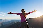 Rear view of young female trail runner with open arms on Pacific Crest Trail, Pine Valley, California, USA