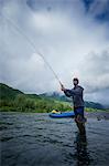Man fishing in river, Kodiak, Alaska, USA