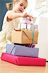 Girl on birthday looking at stack of presents, Munich, Bavaria, Germany