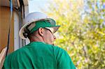 Solar panel installation worker, rear view