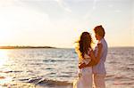 Young couple embracing on beach at sunset, Dalmatia, Croatia