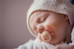 Baby girl sleeping with pacifier in mouth