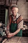 Senior carpenter in his workshop using wood plane, Karanac, Baranja, Croatia