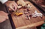 Person preparing dish, cutting ingredients