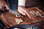 Unrecognizable person cutting garlic