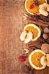 Christmas frame. Spices and dried orange sliceson on a wooden table