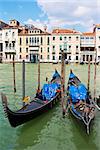 Two gondolas on the Grand Canal in Venice with old beautiful buildings in the background