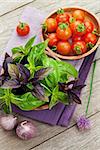 Fresh farmers basil and tomatoes on wood table