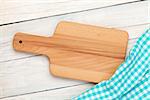 Kitchen utensils over white wooden table background. View from above with copy space