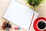 Office desk table with supplies, coffee cup and flower. Top view with copy space