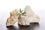 Culinary cheese eating. Goat cheese and cream cheese with fresh herbs isolated. Delicious cheese eating.