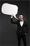 Handsome latino young man holding a speach balloon