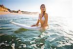 Beautiful young girl surfing