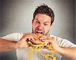 Man eating a sandwich with violent impetuosity