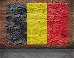 Flag of Belgium painted over aged brick wall