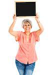 Happy elderly woman holding a chalkboard, isolated on a gray background