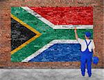 House painter paints flag of Republic of South Africa on old brick wall