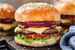 Delicious burger with beef, bacon, cheese and vegetables