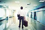 Businessman in airport ready to travel with aircraft