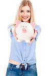 Beautiful and attractive blonde woman holding and showing a piggy bank, isolated over white background