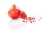 Pomegranate background. Whole pomegranate and pomegranate core isolated on white background. Healthy fruit eating, super foods.