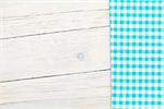 Blue towel over wooden kitchen table. View from above with copy space