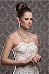 lovely brunette with elegant hair-style and dress, stylish make-up and pearls jewellery