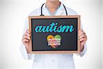 The word autism and doctor showing little blackboard against autism awareness month