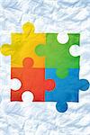 Autism awareness jigsaw against crumpled white page