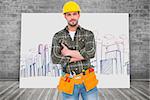 Manual worker with tool belt  against composite image of white card