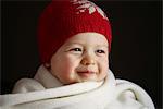 A 15 months baby boy with a cap and a scarf
