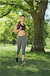 Close-up of a young woman exercising, running in a park in spring, Bavaria, Germany